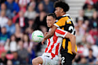 Hull City’s Lucas Herrington challenges Stoke’s Robert Bozenik in their Carabao Cup tie.