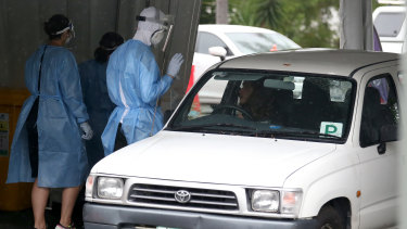A worker tests a resident at a drive-through COVID-19 testing centre in Brisbane on Friday.
