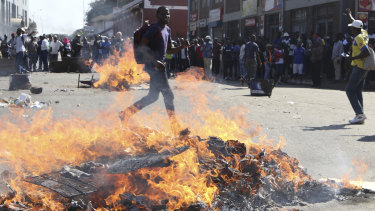 Opposition MDC party supporters protest in the streets of Harare during clashes with police.