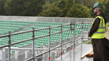 Capuchin priest friar Bryan Shortall from Dublin looks out from the wet stage during preparations are underway to build the stage for the Pope in Phoenix Park, Dublin.