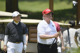 Donald Trump, pictured with former Japanese prime minister Shinzo Abe, regularly plays golf.