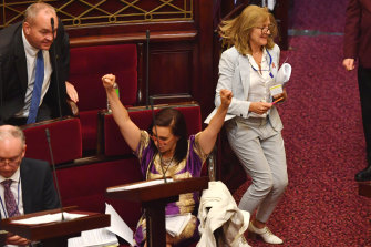 Independent Catherine Cumming (seated) and the Reason Party’s Fiona Patten celebrate the end of the debate.