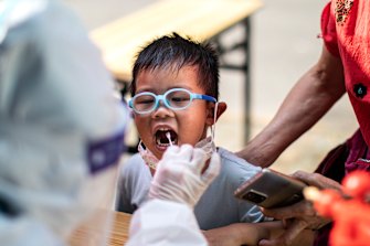 A medical worker takes samples during a mass COVID-19 test this week in a residential block in Wuhan, Hubei Province, China. 