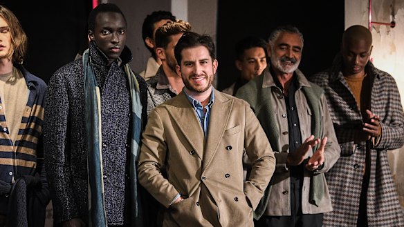 Designer Christian Kimber (centre) on the runway with models during Fashion Week 2021.