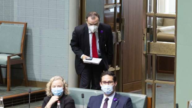 Labor MP Graham Perrett leaves the chamber under standing order 94a during question time.
