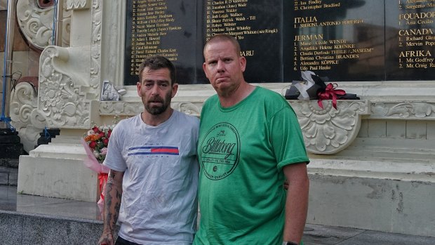 Dale Kennedy of Perth, left, visits the Bali bombings monument at Kuta to pay respects to his school friend Dean Gallagher. Also pictured is Gallagher family friend Gary Clark.