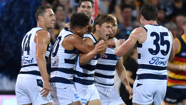 Geelong's Tom Atkins celebrates a goal against Adelaide with teammates on Thursday night.