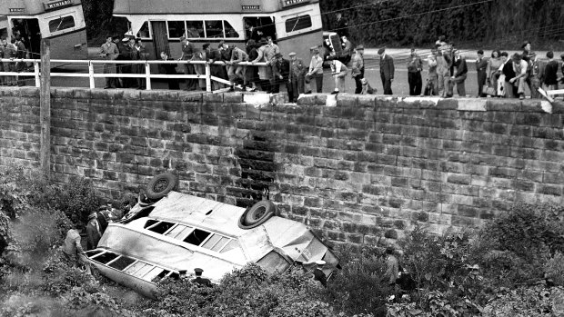 The double decker bus crashed through the safety fence and dropped on to its side below.