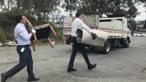 Field Services chairman and lord mayor Graham Quirk cleaning up dumped rubbish at Murarrie.