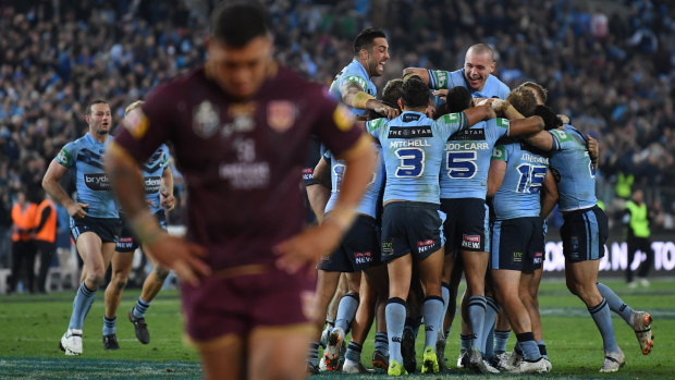 Agony and ecstasy: Josh Papalii leaves the field as the Blues celebrate.