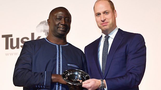 Winner of the 2019 Tusk Award for Conservation in Africa Tomas Diagne poses with Britain's Prince William in London.