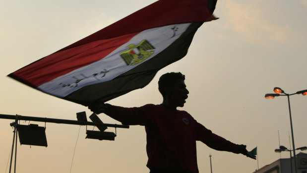 A protester waves the Egyptian flag during demonstrations in Cairo's Tahrir Square in late 2011.