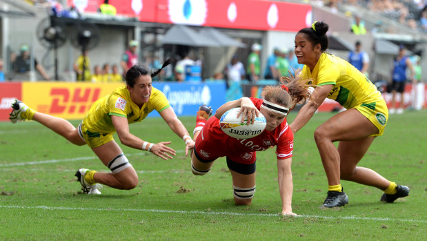 Karen Paquin goes over for another try to Canada.