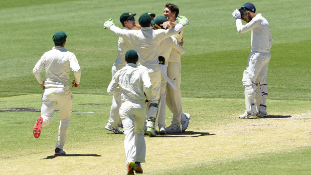 Jubilant: Australia celebrate, but not too much, the final wicket of the match.