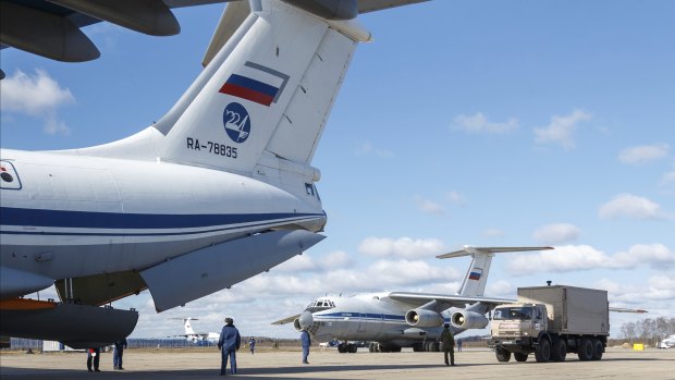 Nine Il-76 cargo planes are loaded at the Chkalovsky military airport in Moscow as Russia prepares to send medical personnel and supplies to Italy to help the country's efforts against the coronavirus. 