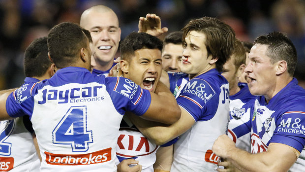 Joy and relief: Bulldogs players celebrate a try in Newcastle.