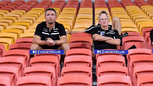 Rugby league in the coronavirus age: Souths’ Sam Burgess and Wayne Bennett swap the coaches’ box for the grandstand at an empty Suncorp Stadium on Friday night. When there were still games being played.