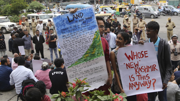 Indian activists protest the Kashmir decree in Bangalore, India.