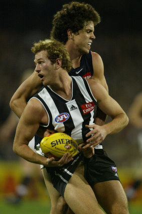 Justin Davies grabs Collingwood’s Ben Johnson by the shorts.