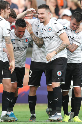 Jamie Maclaren celebrates his hat-trick with  City teammates.