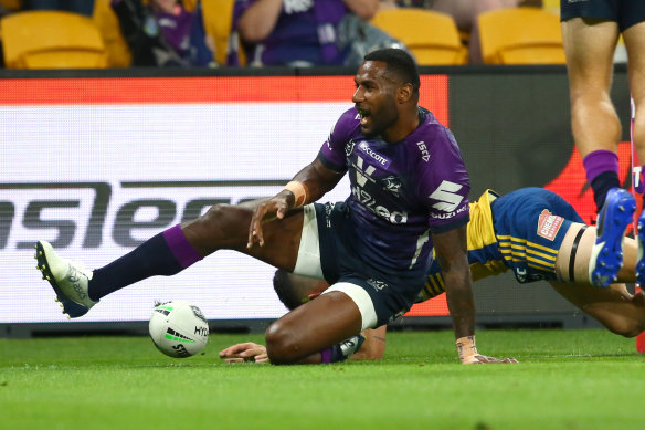 Suliasi Vunivalu crosses for a Storm try at Suncorp Stadium.