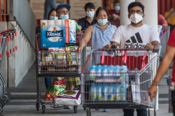 Shoppers stock up at Costco in the Melbourne Docklands before a five-day lockdown. 