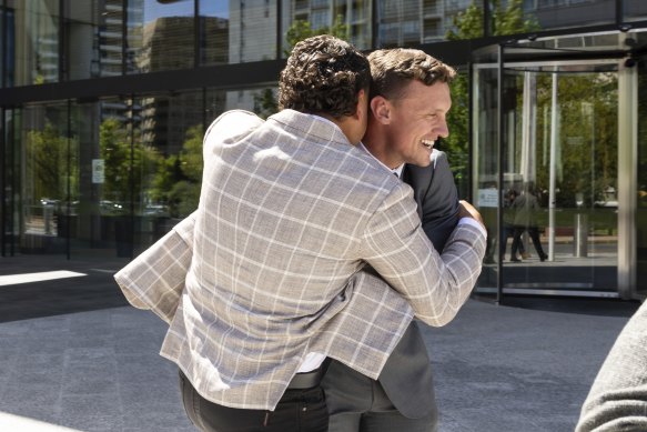 Latrell Mitchell and Jack Wighton embrace outside the ACT Magistrates Court.