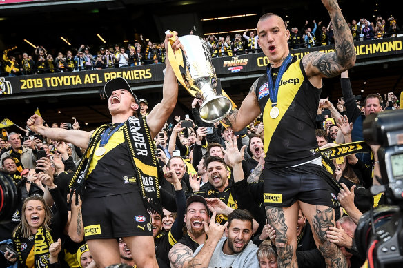 Liam Baker (left) celebrates the Tigers’  2019 premiership with star teammate Dustin Martin.