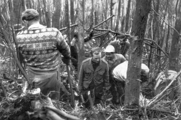 Police and civilians force a passage through the matted undergrowth towards the Southern Cloud.