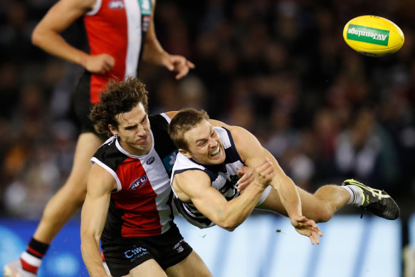 Geelong’s Tom Atkins is tackled by St Kilda’s Max King.