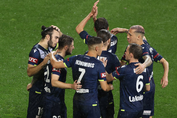 Melbourne Victory players celebrate a goal against Wellington Phoenix.