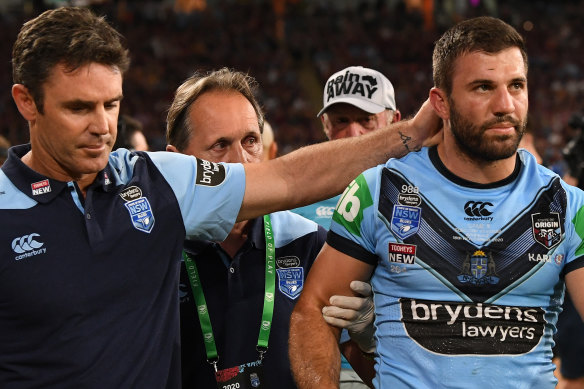 Brad Fittler consoles a heavily concussed James Tedesco.