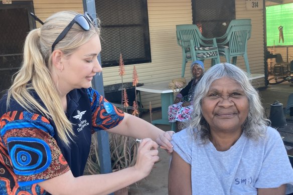 Cheryl Stewart receives her first dose of Pfizer during a RFDS visit to the remote South Australian town of Oodnadatta. Just 16 per cent of Indigenous Australians are fully vaccinated.