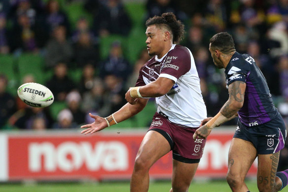 Moses Suli of the Sea Eagles under pressure from Josh Addo-Carr of the Storm.