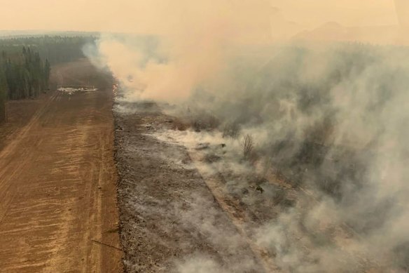A burned section of forest in the area near Edson, Alberta smoulders.