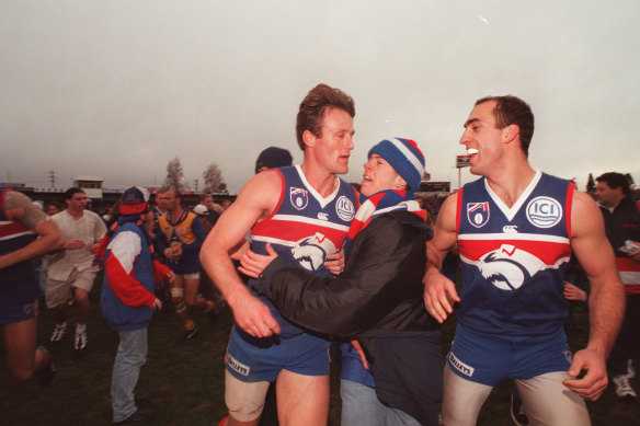 Chris Grant and Matthew Croft leave the field after defeating West Coast in the last AFL match to be played at Whitten Oval.