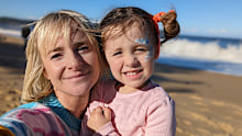 Lydia Stone, three, with her mum Cordelia at the beach, just weeks before she developed a life-threatening case of influenza.