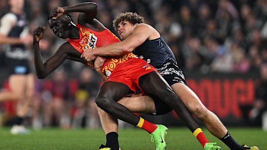 Mac Andrew is tackled by Carlton’s Charlie Curnow. Damien Hardwick pointed to another contest between the duo.