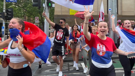 Serbian fans celebrate the news that Novak Djokovic had his visa cancellation overturned and was being released from detention.