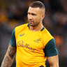 Quade Cooper speaks to coaching and medical staff during the warm-up before the first Test against England. 