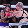 Alma Garcia, left, takes a hit from Bec Rawlings during a 125-pound bout at the Bare Knuckle Fighting Championship at the Ice and Events Center Saturday, June 2, 2018, in Cheyenne, Wyo. Rawlings won the bout. (AP Photo/Michael Smith)