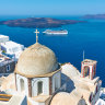 Fira town in Santorini island in Greece with cruise ship in the background.