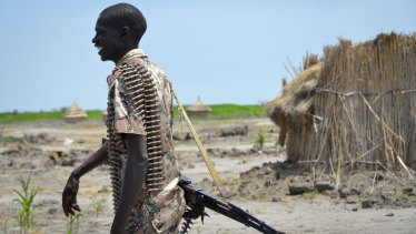 A government soldier walks to his post to patrol the border in Kuek, in northern Upper Nile state, South Sudan in 2017.