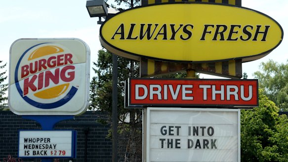 A Burger King sign and a Tim Hortons sign are displayed in Ottawa, Ontario. American brands are part of the landscape in Canada.