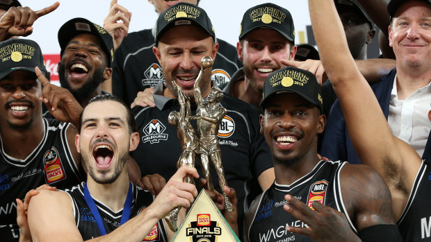 Chris Goulding, left, and Casey Prather celebrate with the trophy after game five of the NBL finals between Melbourne United and the Adelaide 36ers at Hisense Arena.