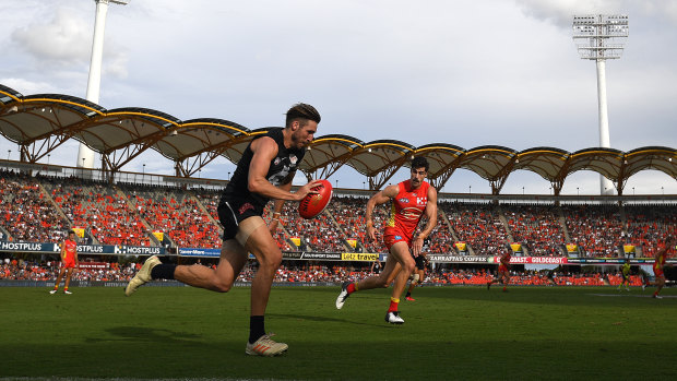 Still got the Blues: Carlton's Dale Thomas races up the wing at Metricon Stadium on the Gold Coast.
