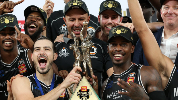 Melbourne United's Chris Goulding (bottom left) celebrates with his teammates after winning the 2018 NBL grand final series. 