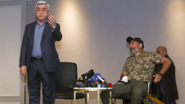 Serzh Sargsyan, left, gestures as he leaves a meeting with protest leader Nikol Pashinian, right, in Yerevan on Sunday.