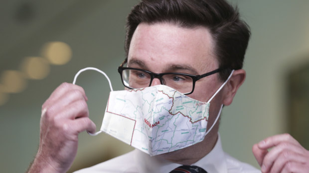 Deputy Nationals leader David Littleproud sporting a mask printed with the map of his Queensland electorate.