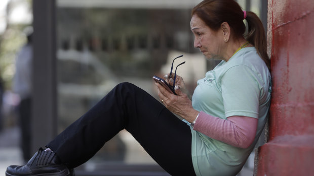A women checks her mobile phone in Sao Paulo, Brazil.